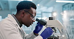 Scientist, black man and microscope or writing in laboratory for results on medical research and experiment. Notebook, professional and expert with notes on science development, study review and info