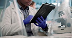 Night, science and man with tablet in laboratory for medical research, microscope data and analysis. Healthcare, black person or scientist with digital for biotechnology, scroll or typing results