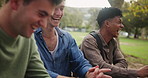 Happy, people and relax with laughing in park for funny conversation, humor and outdoor bonding. College, friends and students with smile in nature for and comedy, humour joke in discussion together