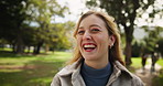 Happy, woman and face with laughing in park for outdoor adventure, humor or fun on weekend trip. Nature, relax and female person with smile in forest for comedy, travel or vacation in New Zealand