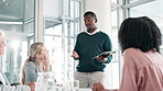 Black man, tablet and coaching with team in presentation for meeting, strategy or collaboration at office. Young African, male person or employee talking to group with technology for discussion