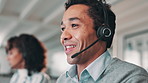 Happy man, consultant and typing with headphones in call center, customer service or telemarketing at office. Male person or agent talking with mic on computer for online advice or help at workplace