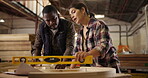 Carpenters, level and pencil with measurement for construction, furniture or project. People, partners and discussing with tools in a creative carpentry workshop for manufacturing, art and craft