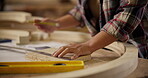 Carpenter, hands and pencil with ruler for construction notes, furniture or project plans. Closeup of person cutting wood with tools in a creative carpentry workshop for manufacturing, art and craft