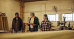 People, carpenter and tablet with team in discussion for project, design or construction at workshop. Group of woodworkers or artisan walking with technology in conversation on inventory at warehouse