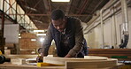 Carpenter, drawing and pencil with product design for construction, furniture or project. Black man, planning and wood with tools in a creative carpentry workshop for manufacturing, art and craft