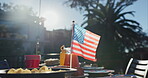 USA, flag and backyard with holiday party at independence day celebration of culture. American, picnic and freedom on vacation event in summer with beer, bbq or national pride for country victory