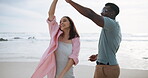 Couple, outdoor and dancing with love by ocean for freedom on romantic holiday, travel and bonding in California. Man, woman and together with movement on vacation by beach waves, happy and support.