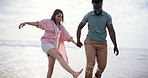 Beach, play and interracial couple for romance, honeymoon and travel for fun, happy and walking. Woman, holding hands or sea on date to show partner adventure, happiness or bonding or joy on holiday