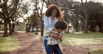 Spinning, mother and child in park for playful, entertainment and bonding together outdoor. Nature, playground and funny game with happy family, mom and son with circle movement on weekend holiday