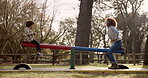 Park, mother and child on seesaw for playing, riding and bonding together on holiday weekend. Nature, playground equipment and entertainment of happy family, mom and son with balance for fun outdoor