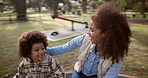 Park, mother and child on carousel for fun, riding and bonding on merry go around. Nature, playground equipment and entertainment of happy family, mom and son with balance for playing outdoor