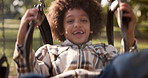 Mother, child and playing with swing at park for fun ride, bonding or outdoor holiday weekend in nature. Happy little boy, child or kid with parent in joy, happiness or cheerful playground in woods