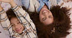 Happy mother, child and relax with autumn leaves above at park for bonding, holiday or weekend in nature. Top view of mom lying with little boy or kid for fun outdoor season, love or support together