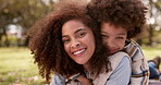 Happy mother, child and relax with hug at park for bonding, love or embrace together on grass field. Portrait of mom, little boy or young kid with smile for care, support or fun childhood in nature