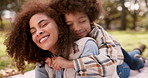 Happy mother, child and relax with hug on grass field at park for outdoor bonding, love or embrace together. Mom, little boy or young kid lying with smile for care, support or fun childhood in nature