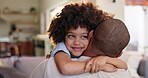 Child, hug and father with love at house for support, safety or care by bonding together in childhood. Smile, boy and man relax in embrace of gratitude, trust or security of parent in living room