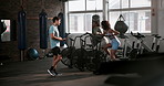 Personal trainer, women and fitness on bike in gym with cardio, exercise and support for workout with motivation. Instructor, athlete and aerobic machine with training, healthy body or cheering coach