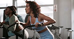 Woman, bike and workout in gym for fitness with cardio training, endurance and wellness challenge. Athlete, person and aerobic machine or sweating with hard work, determination and intense exercise