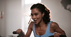 Woman, bike and happy in gym for fitness with cardio exercise, endurance or energy for wellness challenge. Athlete, person or aerobic machine with hard work, crossfit determination or intense workout