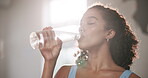 Woman, drinking water and health in gym with exercise for fitness break, thirsty and hydration for body wellness. Athlete, person and lens flare with liquid or rest from training or physical activity