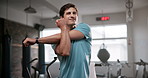 Happy man, fitness and stretching with arms at gym for workout, exercise or training. Young and active male person in body warm up, preparation or getting ready for wellness at indoor health club