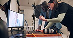 Photographer, team and production on laptop in studio editing photoshoot pictures, digital art or project process. Woman, man editor and backstage on screen with photography catalog for magazine


