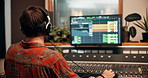 Computer, recording studio and man with sound board, screen and mixer for music, audio engineering or technology. Song composition, artist or producer with equipment, headphones or media album mixing