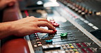 Studio, hand and person with audio mixer for volume level, frequency change and control. Producer, sound engineer and music equipment for track record, consistency and creativity with workstation
