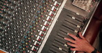 Studio, hand and person with music mixer for volume level, frequency change and control. Producer, sound engineer and audio equipment for track record, consistency and creativity with settings