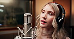 Recording, artist and woman with singing in studio for entertainment, production and record label. Musician, headphones and music with microphone for audio media, sound or broadcast of song for album