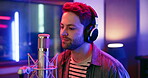 Production, artist and man with singing in studio for sound media, recording or song in album. Musician, microphone and neon with headphones for audio, entertainment or live broadcast at record label