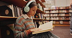 Music, headphones or girl in library reading book at university, college or school campus for education. Relax, learning or smart student with scholarship studying knowledge, research and information