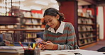 Happy, phone and woman student in library networking on internet, mobile app or social media. Smile, technology and female person reading university email for scholarship approval on cellphone.