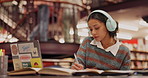 Headphones, library and woman student writing notes for information, knowledge or research for test. Education, college and female person study for exam with books and laptop for listening to music.