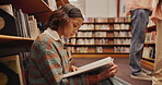 Student, woman and book on floor in library for reading, literature research or studying for knowledge. Gen z girl, novel or search for academic information for scholarship with education or learning