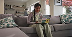 Woman, typing and couch with laptop for work from home, elearning and online course with smile. Writing, email and search on a website for digital copywriting program in a lounge with technology 