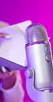 Microphone, book and hands of person on pink background for audio or sound therapy and podcast. Woman, influencer and live streaming for sleeping or mental health and sensation for relaxation or calm