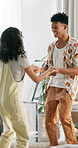 Dancing, happy and couple with boxes in new home listening to music, playlist or radio. Moving, love and young man and woman bonding and groove together to song for celebration in modern apartment.