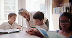 Educator, students and books in classroom together for educational development, group learning and growth. Children, reading or studying in school for support, knowledge and storytelling or bonding