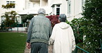 Old couple, holding hands and back in garden for retirement, discussion or outdoor in nature by lawn. Elderly woman, man and together for care, bonding and love on path at nursing home in New Orleans