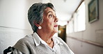 Elderly woman, wheelchair and planning by window in nursing home, reflection or thinking for health. Thoughtful, memory and person with disability in wellness center, nostalgia for youth in hallway