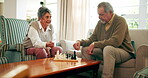 Senior couple, home and smile with chess game at living room for fun, challenge and retirement. Relationship, love and people bonding in lounge as pensioner for support, care and trust for recreation