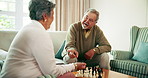 Home, love and senior couple with chessboard, playing or conversation with hobby in living room. People, apartment or old man teaching mature woman, game or explain rules with fun or bonding together