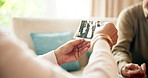 Photograph, senior couple and hands in retirement home with memory, people and vintage picture. Remember, love and marriage in a living room with retro wedding photo for nostalgia together on a sofa