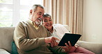 Happy, tablet and senior couple on couch for streaming movie, online game and retirement in home. Smile, elderly man and woman on sofa with tech for digital picture album, relax and bonding for love