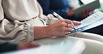 Business person, hands and writing with document in meeting, seminar or staff training at office. Closeup of employee or trainee checking information and taking notes on paperwork for presentation