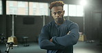 Arms crossed, fitness and serious with man in gym for start of exercise, training or workout routine. Confident, performance and portrait of African person in health club for challenge or improvement