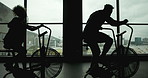 Fitness, bicycle machine and people in gym for exercise, intense workout and silhouette in sports club. Spin class, group and cycling on equipment for wellness, cardio and endurance or weight loss