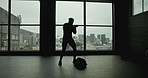 Silhouette, gym and man with bag for boxing, fight or exercise healthy body for wellness. Shadow boxer, sport and person practice martial arts, mma or walking at club to punch with energy for fitness